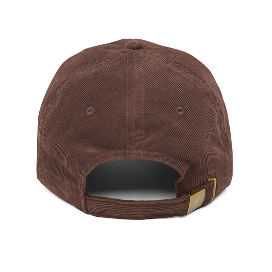 Back side of brown cap with a gold buckle on a white background